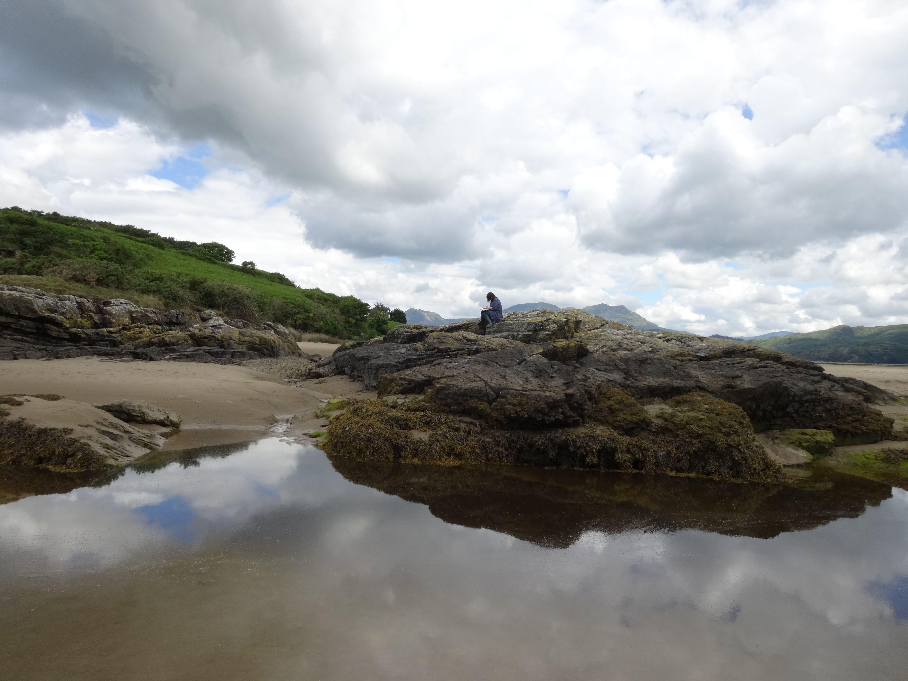 sketching on a rock