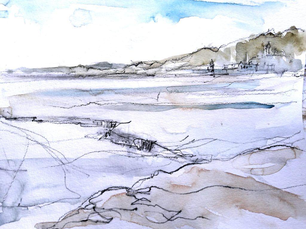 View towards Portmeirion from Ynys Gifftan at low tide on a bright, sunny day