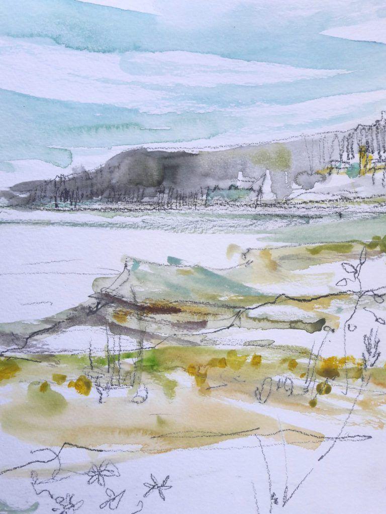 View towards Portmeirion from Ynys Gifftan at low tide on a bright, sunny day