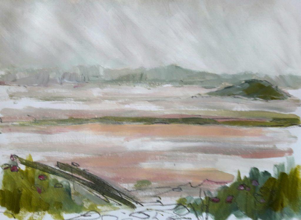 View over estuary with misty hills beyond