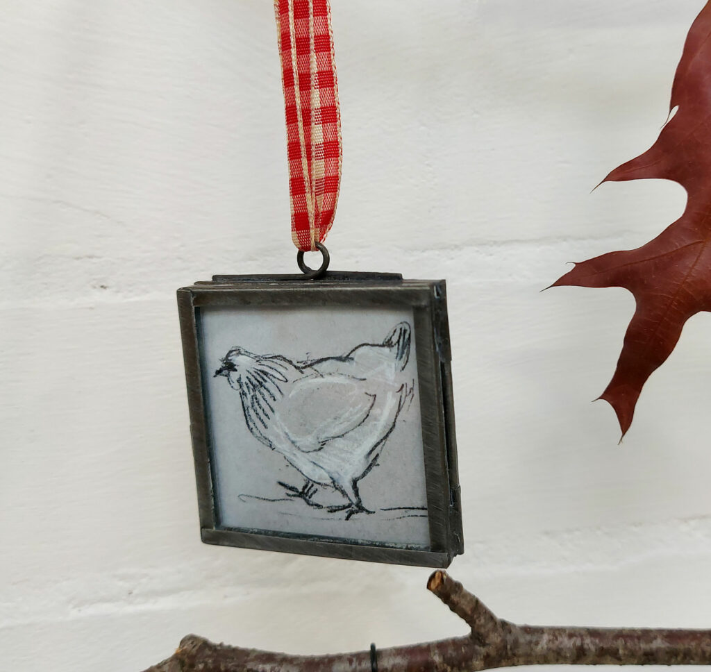 Chicken design, in a zinc frame with red gingham ribbon