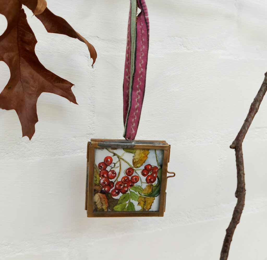 Hawthorn design, in a brass frame with recycled sari ribbon