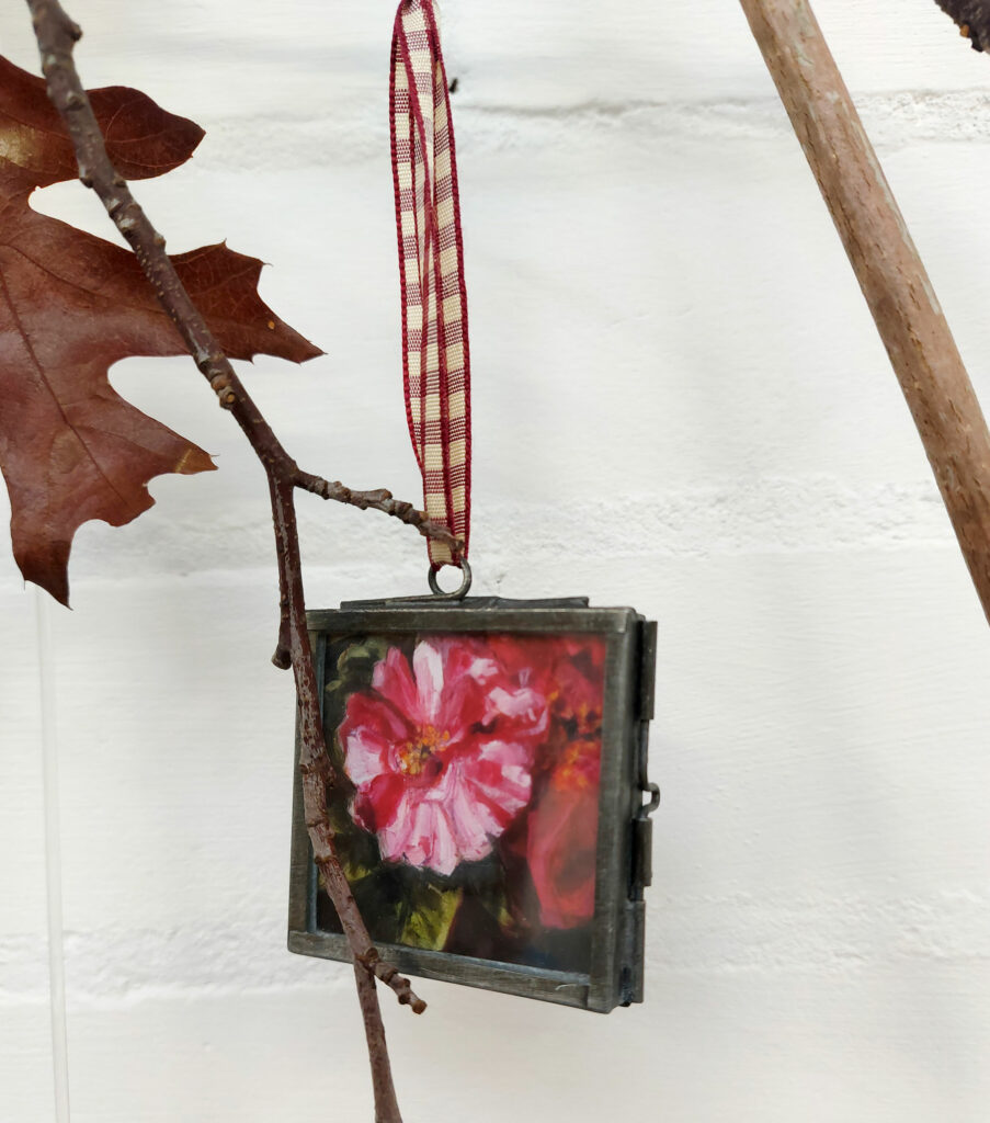 Rosa Mundi design, in a brass frame with dark red gingham ribbon